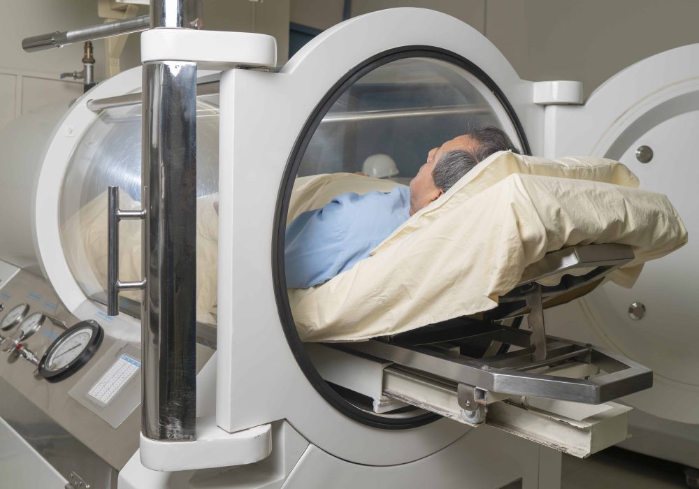 Man inside a machine for hyperbaric treatment